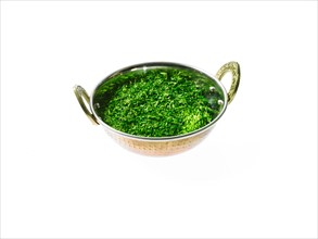 Studio shot of Parsley Flakes in pan on white background. Photo: David Arky