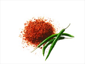 Studio shot of Red Chili Powder and Whole Green Chilies on white background. Photo: David Arky