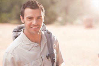 Young man hiking in desert. Photo : db2stock
