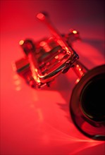 Close up of trumpet on red background. Photo : Daniel Grill