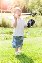 Cute boy (2-3) playing baseball. Photo: Take A Pix Media