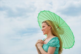 Woman holding parasol.