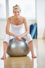 Woman sitting on fitness ball.