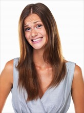 Studio portrait of woman with fake smile. Photo: momentimages