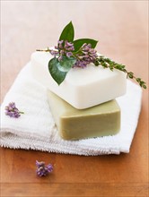 Lavender and soap bars on towel.