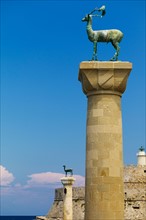 Greece, Rhodes, Mandraki Harbor, Statues on columns.