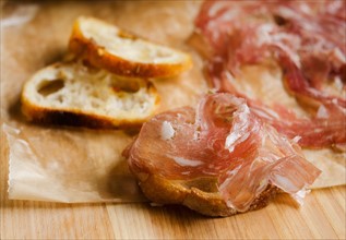 Fresh prosciutto ham with bread.