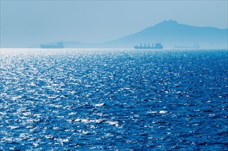 Greece, Oil tankers and cargo ships on Aegean Sea.