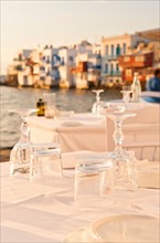 Greece, Cyclades Islands, Mykonos, Set tables by sea.
