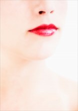 Studio shot of young woman wearing red lipstick.