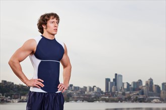 USA, Washington State, Seattle, Young athlete doing workout, skyline in background. Photo: Take A