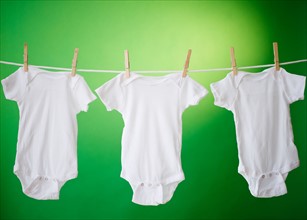 Close up of baby clothes hanging on clothesline. Photo : Jamie Grill