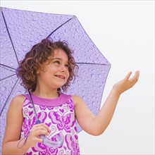 Girl (6-7) with umbrella.