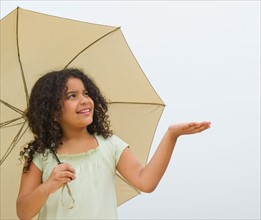 Girl (8-9) with umbrella.