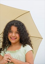 Portrait of girl (8-9) with umbrella.