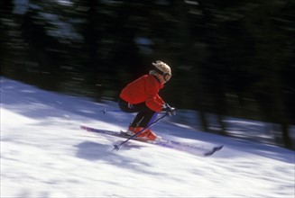 USA, California, Lake Tahoe, Boy (10-11) skiing down slope. Photo: John Kelly