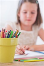 Close up of girl (6-7) drawing in notebook. Photo: Daniel Grill