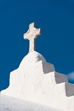 Greece, Cyclades Islands, Mykonos, Cross on church roof.