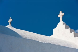 Greece, Cyclades Islands, Mykonos, Crosses on church roof.
