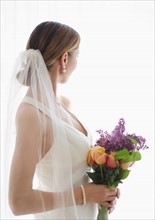 Bride holding floral bouquet.