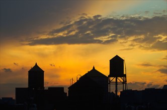 USA, New York, New York City, Skyline silhouette at sunset.