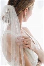 Bride wearing veil.