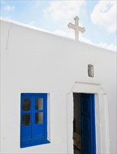 Greece, Cyclades Islands, Mykonos, Church with cross on roof.