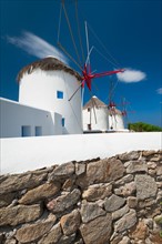 Greece, Cyclades Islands, Mykonos, Stone wall near old windmills.