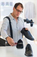 Man choosing shoes in store.