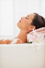 Young woman taking bath.