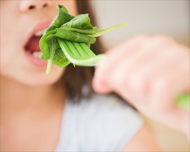 Close up of girl (10-11) eating salad. Photo: Jamie Grill