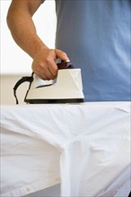 Man ironing shirt.