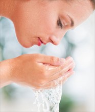 Woman washing face.