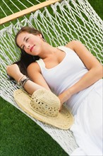 Woman relaxing in hammock.