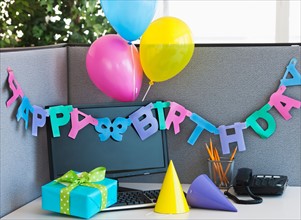 Close up of birthday decorations on office desk. Photo: Daniel Grill