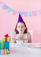 Portrait of girl (6-7) celebrating birthday. Photo: Daniel Grill