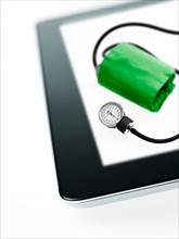 Studio shot of blood pressure gauge on digital tablet. Photo : David Arky