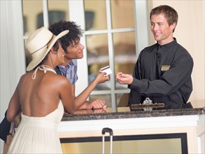 Couple checking in to hotel. Photo: db2stock