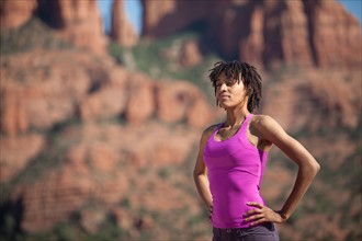 USA, Arizona, Sedona, Young woman standing at desert. Photo : db2stock