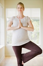 Pregnant woman practicing yoga. Photo : Rob Lewine