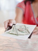 Woman taking money. Photo: Jamie Grill