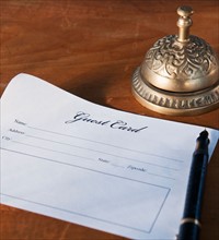 Close up of antique guest card and service bell. Photo: Daniel Grill