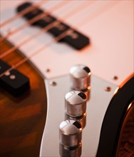Close up of volume knobs of bass guitar. Photo: Daniel Grill