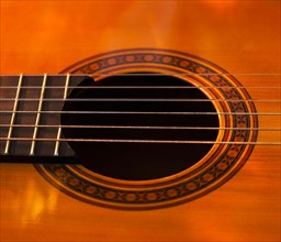 Close up of sound hole of acoustic guitar. Photo: Daniel Grill