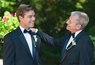 Father with bridegroom at wedding.