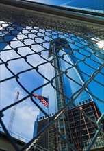 USA, New York, New York City, Lower Manhattan, Ground Zero, Freedom Tower seen through chainlink fence.