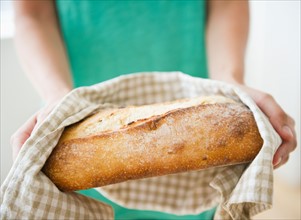 Close up of woman's hand holding freshly baked bread. Photo: Jamie Grill