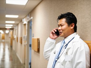 Portrait of doctor talking on mobile phone.