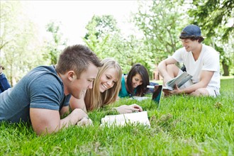 College students relaxing on grass. Photo : Take A Pix Media