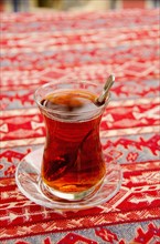 Turkey, Istanbul, glass of tea on table. Photo: Tetra Images
